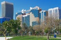 Cityscape with beautiful landscaped green public park with palm trees against modern residential buildings in Abu Dhabi, UAE