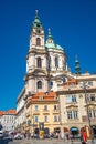 Cityscape with beautiful old buildings in the historical downtown at Saint Nicholas Church in Prague, Czech Republic, with people Royalty Free Stock Photo