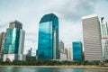 Cityscape of Benchakitti park with lake view and skyscrapers during daytime. Bangkok