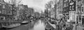 Cityscape, black-and-white panorama - view of city channel with boats