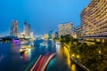 Cityscape of boat light trails on Chao Phraya River night scene in Bangkok, Thailand