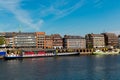 Cityscape of Bremen with old architecture, historical wooden sailing ships and barge floating along the river Weser