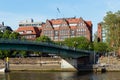 Cityscape of Bremen with old architecture, historical wooden sailing ships and barge floating along the river Weser