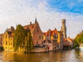 Cityscape of Bruges, Flanders, Belgium. Water canal at Rozenhoedkaai with old brick buildings and Belfry Tower on Royalty Free Stock Photo