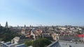 A cityscape captured from an elevated viewpoint on a radiant summer day