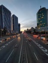 Cityscape with car traffic on a road with three lanes of traffic in the evening city. Kyiv, Ukraine Royalty Free Stock Photo