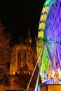 Cityscape of Cologne, Germany, featuring a mix of illuminated buildings and a Ferris wheel