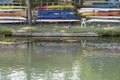 colorful kayaks on racks at river Sile embankment, Treviso, Italy