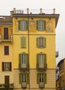 Cityscape of decorated faÃ§ade with wood green shutters Como Italy