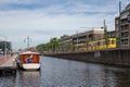 Cityscape Delft with canal and passing tram to railway station