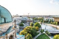 Cityscape of downtown of Berlin with modern skylines at the riverbank of Spree River and church towers under sunset. Aerial view