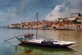 Porto old city view with traditional boat on Douro river