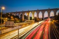 Cityscape at dusk - highway traffic near Campolide station car lights trails. Lisbon, Portugal