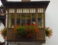 Cityscape of FaÃ§ade and flowers on balcony, in Cortina dAmpezzo, Province of Belluno, Italy
