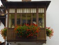 Cityscape of FaÃ§ade and flowers on balcony, in Cortina dAmpezzo, Province of Belluno, Italy Royalty Free Stock Photo