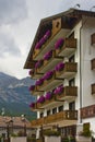 Cityscape of FaÃ§ade and flowers on balconies, in Cortina dAmpezzo, Province of Belluno, Italy