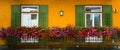 Cityscape of FaÃ§ade and flowers on balcony, in Cortina dAmpezzo, Province of Belluno, Italy