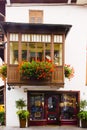 Cityscape of FaÃ§ade and flowers on balcony, in Cortina dAmpezzo, Province of Belluno, Italy Royalty Free Stock Photo