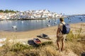 Cityscape of Ferragudo with a tourist admiring this town in the foreground, Portugal Royalty Free Stock Photo