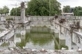 Flooded ruins of collapsed concrete building with seagulls on wrecked pillars and warped reinforcing steel at , Christchurch, New