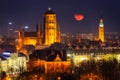 Cityscape of Gdansk with St. Mary Basilica and City Hall with the full moon, Poland Royalty Free Stock Photo