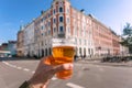 Cityscape and happy visitor of Copenhagen with beer in hand, Denmark. Danish capital with old houses and tourists