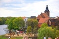 Cityscape of Havelberg at Havel river with its church St. Laurentius. Playground in front with people