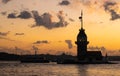 Cityscape of historic Istanbul with the silhouette of famous Maiden`s/Leander`s Tower with cruising ferryboats during the sunset