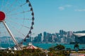 Cityscape of HongKong Island, Central district with skyline and Ferris wheel near Victoria Harbour