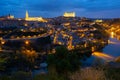 Cityscape of illuminated Toledo in evening with view of Tagus River