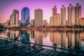 Cityscape image of Benchakitti Park at sunset in Bangkok, Thail