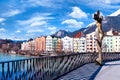 Cityscape of Innsbruck city center with beautiful houses, river Inn and river bridge with sculpture,Tyrolean Alps, Austria, Royalty Free Stock Photo