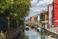 Cityscape on the island of Burano with a canal and bright colorful buildings on the shores, Venice