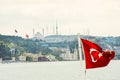 Cityscape of Istanbul with ancient mosques and the old city with turkish flag and ship in front Royalty Free Stock Photo