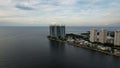 The cityscape of Jakarta city in Indonesia with a view at the sea, port, palms, apartments reflected on the water surface. Jakarta