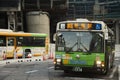 Cityscape and japanese people drive bus on traffic road and stop