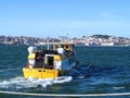 Beautiful cityscape panorama of Lisbon seen from Tejo river with a yellow boat