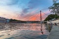 Lyon city at sunset with red footbridge leading to Courthouse Palais de Justice over Saone river Royalty Free Stock Photo