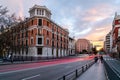 Cityscape of Madrid at sunset. Juan Bravo bridge over Castellana avenue and Ruben Dario Square with light trails of cars