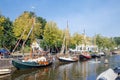 Cityscape medieval city Naarden with canal and historic sailing ships