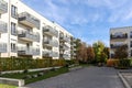 Cityscape with modern residential area, new apartment buildings and green courtyard with pedestrian walkway and trees in autumn Royalty Free Stock Photo