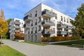 Cityscape with modern residential area, new apartment buildings and green courtyard with pedestrian walkway and trees in autumn