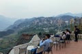 Cityscape on the mountain with fog and trees with tourists relax and sitting for take a view in summer in the dusk in Sa Pa. Royalty Free Stock Photo