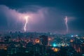 Cityscape at night with two lightning strikes creating dramatic scenery