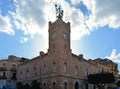 Cityscape with old classical stone brick building of city hall and cloudy blue sky in coastal town Licata in Sicily, Italy