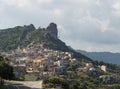 Cityscape of old pictoresque village Ulassai with limestone climbing rock and green vegetation and mountains at