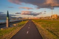 Cityscape over Reykjavik business and touristic downtown, embankment, ocean, harbor, modern buildings with cycling lane at sunset Royalty Free Stock Photo
