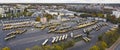 Cityscape panorama. Bird's eye perspective over half-filled bus terminus. Coaches and electrical busses standing