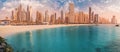 Cityscape panorama of golden sand illuminated by the setting sun in the JBR beach area. Amazing skyscrapers and azure waters