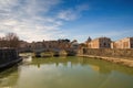 Cityscape and panoramic view of old bridge with warm sunset sky water reflections Royalty Free Stock Photo